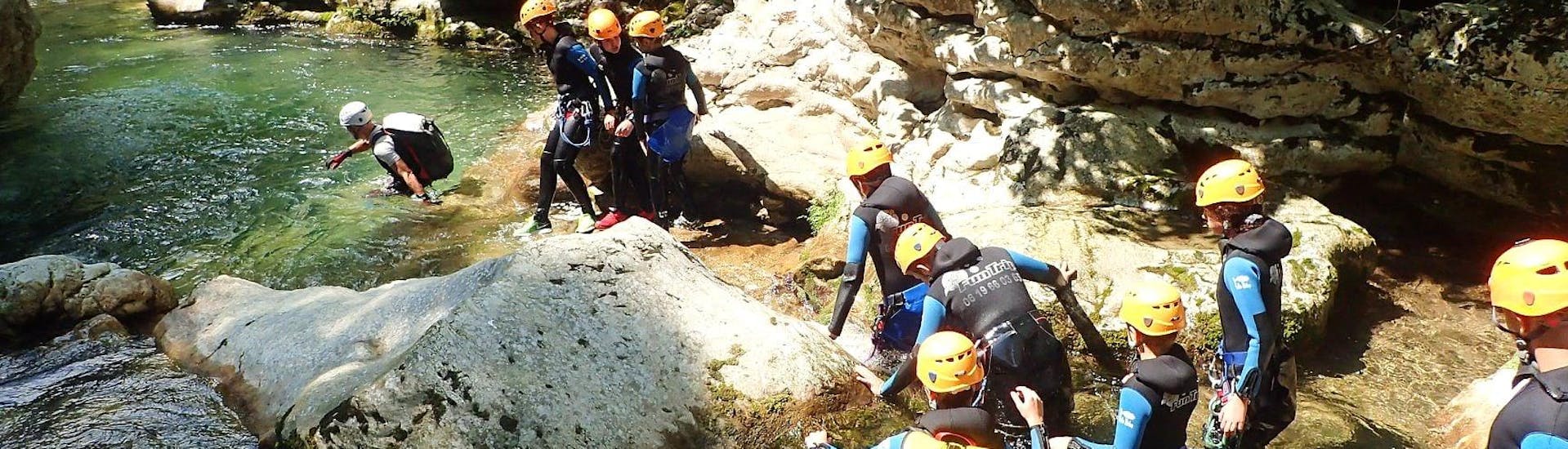 A group of children is advancing in the riverbed during their Canyoning in Gorges du Loup - Level 2 tour with FunTrip.