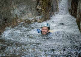 A canyoning enthusiast is swimming in a natural pool during their River Trekking for Families - Canyon de la Basse Besorgues with Les Intraterrestres.