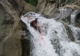 A canyoning enthusiast is abseiling during their Canyoning "Sporty Day" - Canyon du Haut Chassezac with Les Intraterrestres.