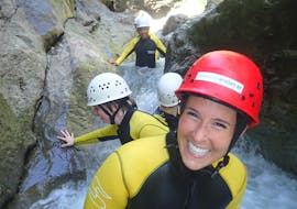 A group of girls is sliding down a natural waterslide during their Canyoning for Beginners with canyoning erleben.