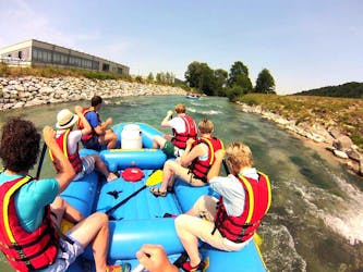 A group of friends is paddling down the Loisach river during their Raft Rental in Farchant with Bavariaraft.