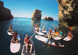 Some friends are paddling on the Praia da Coelha during a private guided tour provided by SUPA Sea Adventures Algarve.