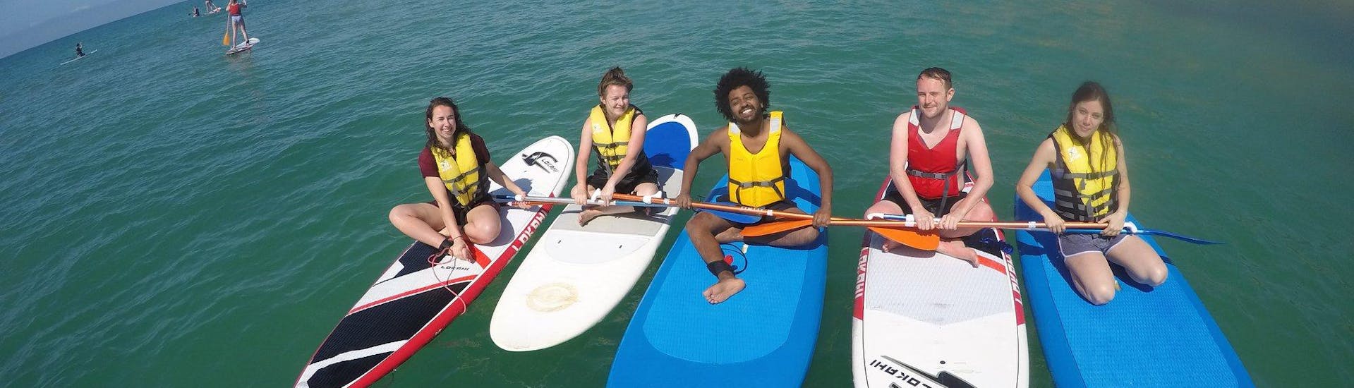 Some friends are paddling on the Praia da Coelha during a private guided tour provided by SUPA Sea Adventures Algarve.