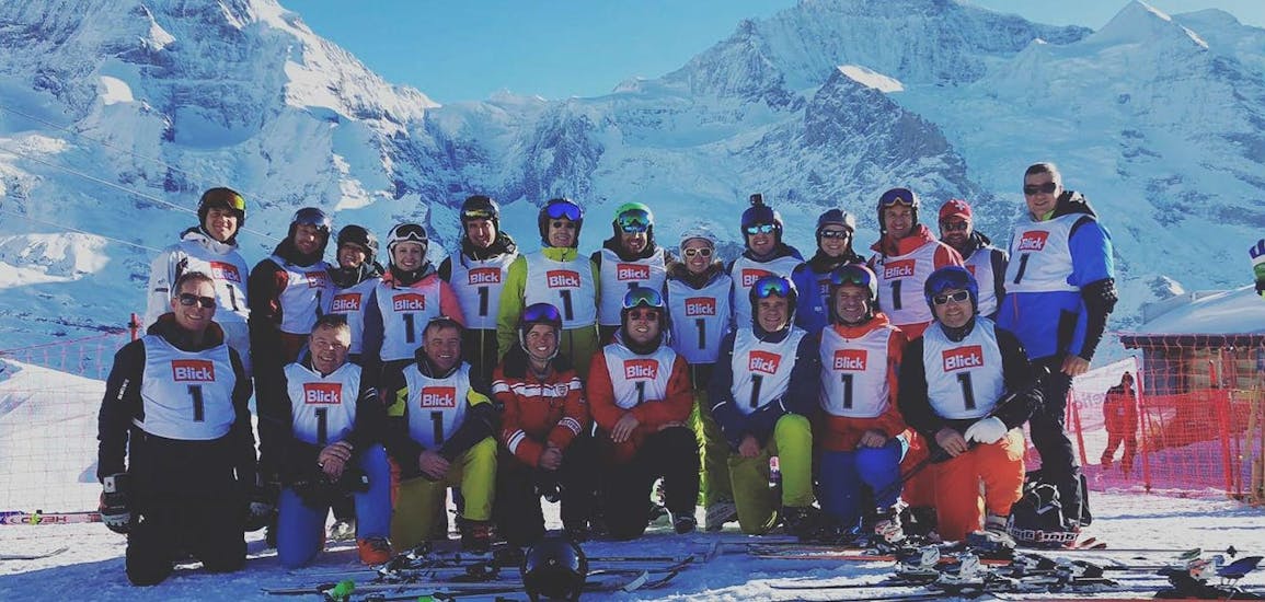 A group picture of adults at their Adult Ski Lessons for Advanced Skiers.