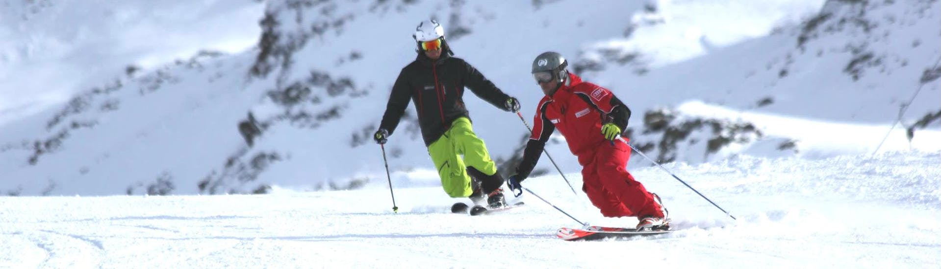 Two skiers skiing during their private ski lessons for adults of all levels with skischule Obergurgl.