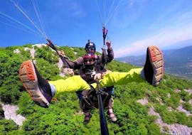 A participant enjoying a paragliding experience over Bjelopolje during a tandem paragliding activity with Sky Riders Paragliding Croatia.