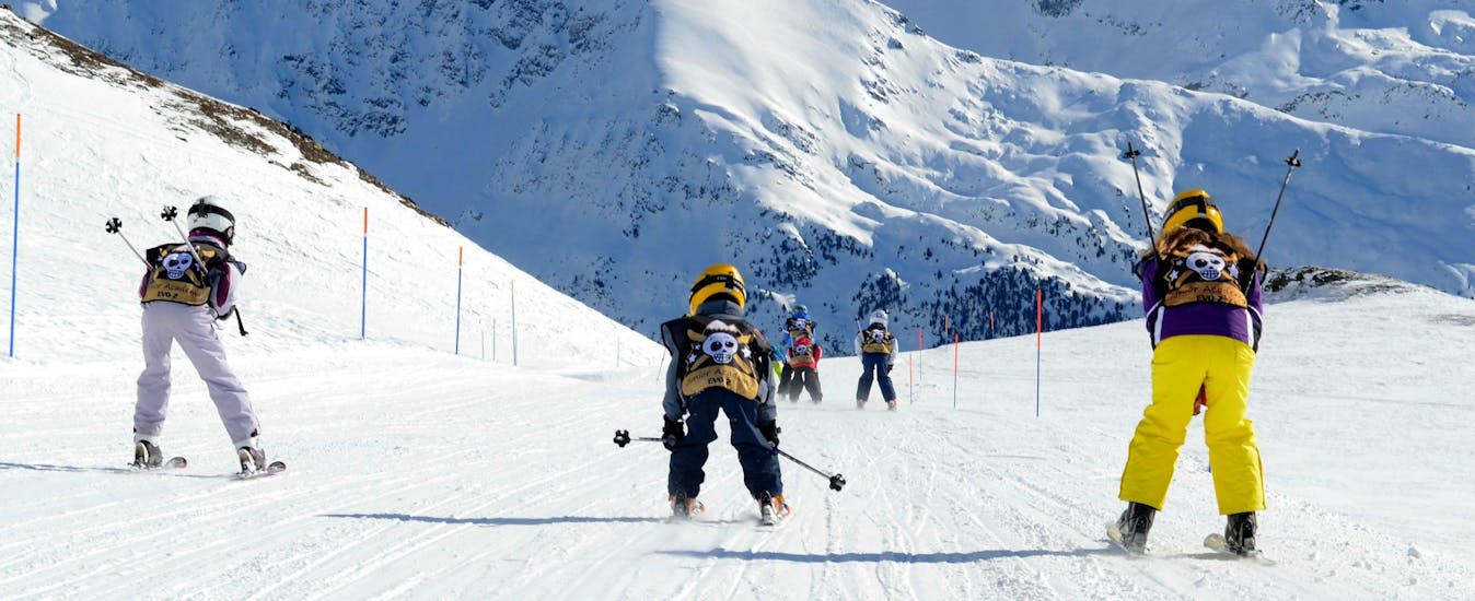 Kids are skiing down a slope during their Kids Ski Lessons (5-12 y.) for All Levels with Evolution 2 Peisey Vallandry.