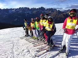 Kids posing for a picture in Andalo during one of the Kids Ski Lessons (6-14 y.) for Beginners.