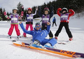 Kids happy with ski instructor in Andalo during one of the Kids Ski Lessons baby Elite.