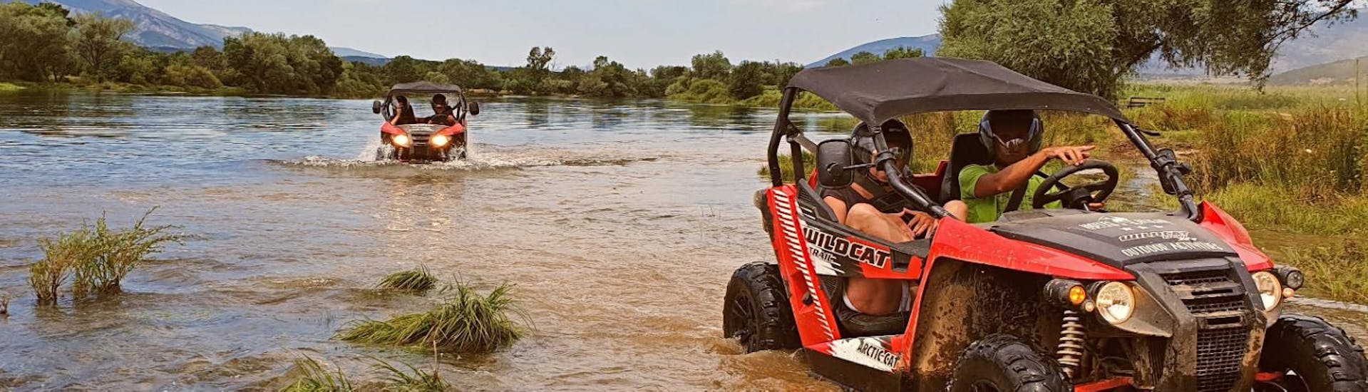 Participants of Cetina River Extreme Buggy Tour from Sinj organised by Hotel Alkar are driving through a river.