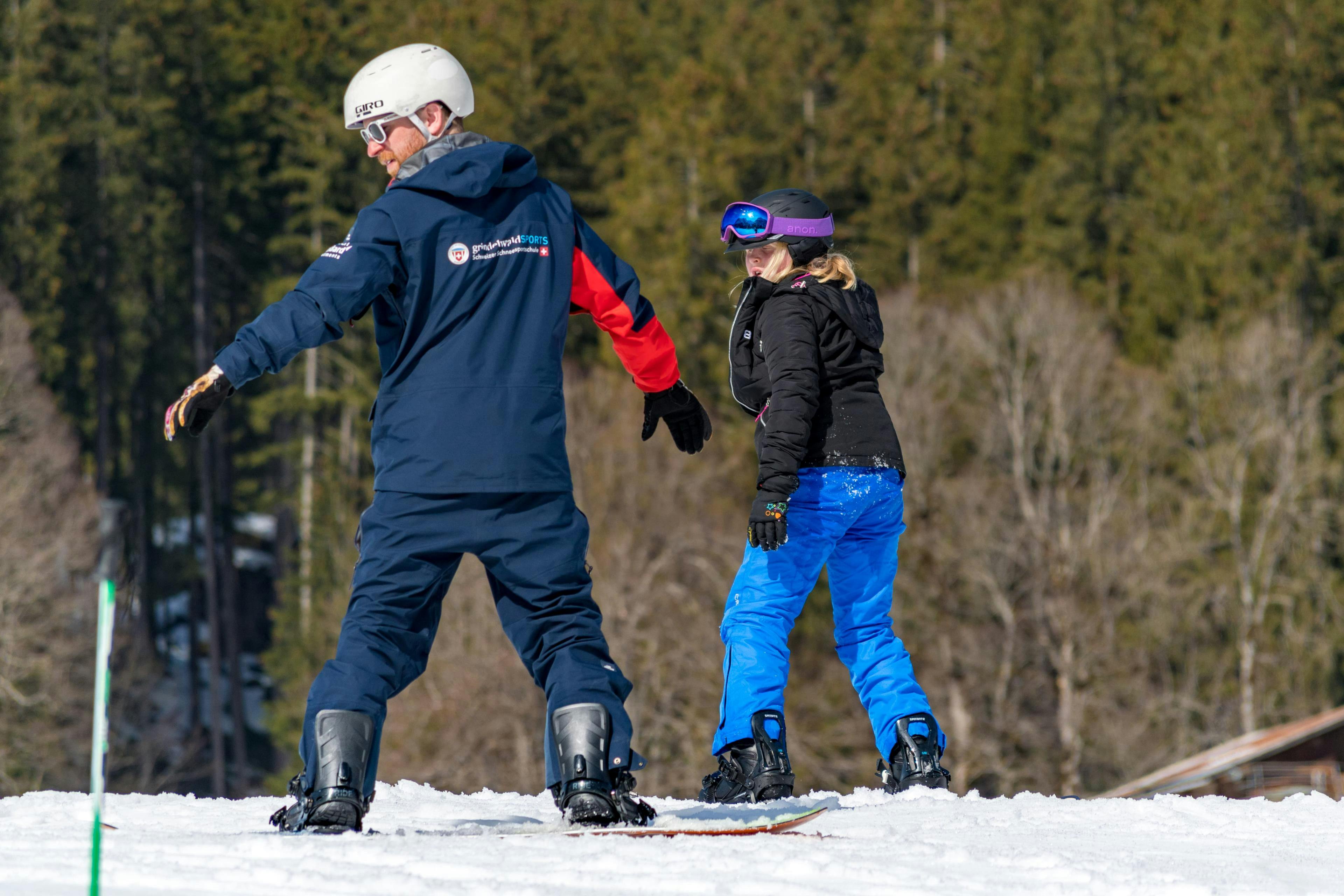 Private Snowboarding Lessons for Kids (from 7 y.) & Adults of All Levels from Swiss Ski School Grindelwald A snowboard instructor from the Swiss Ski School Grindelwald demonstrates exercises for all levels in a private snowboarding lessons for kids and adults.