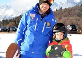 Kid and snowboard instructor in Andalo after one of the Snowboarding Lessons for Kids & Adults of All Levels.