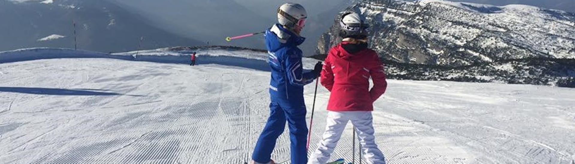 Ski instructor and participant in Andalo during one of the Private Ski Lessons for Adults of All Levels.