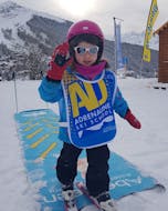 A little girl has fun during her kids ski lessons children from 3 to 5 years 6 Max with Adrenaline Verbier.