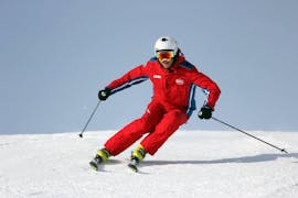 A man is skiing down the slopes during the ski lessons for adults for beginners with skischool SMT Mayrhofen in Zillertal.
