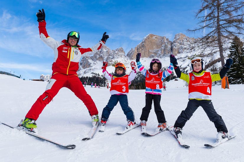 Kids and their ski instructor from Carezza Skischool are on the slopes during Kids Ski Lessons (from 4 years) - Beginner.