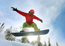 A snowboarder is improving his technique during Private Snowboarding Lessons for Kids & Adults - All Levels with the Carezza Skischool.