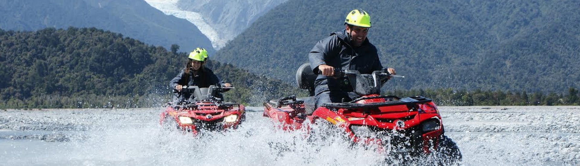 Our guests braving the water trails on their quad bikes with the beautiful Franz Josef Glacier and typically beautiful kiwi mountains in the background. 