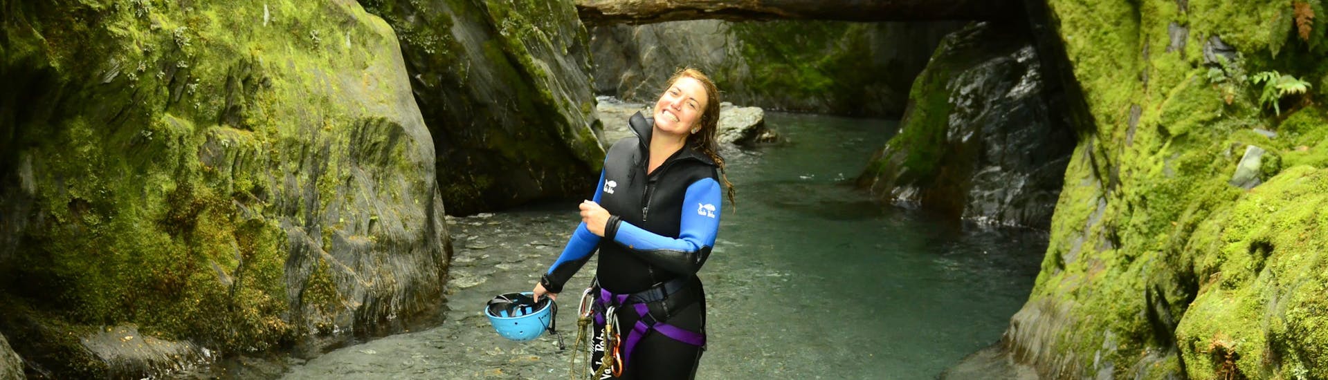 Woman smiling in the green canyon while Canyoning from Queenstown at Mount Aspiring - Full Day with Canyoning New Zealand.