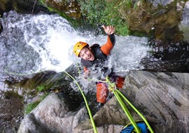 Guy is laughing while he is abseiling in a waterfall at Canyoning from Queenstown at Gibbston Valley - Half Day with Canyoning New Zealand