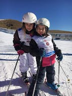 Kids smiling in Monte Pora during one of the kids ski lessons for all levels.