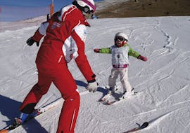A kid is enjoying his first time on the snow in Monte Pora during one of the private ski lessons for kids of all levels.