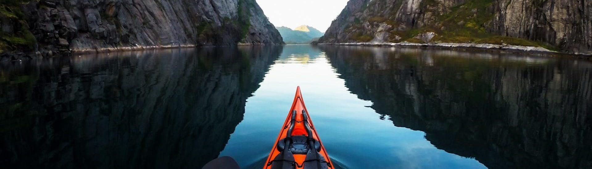 Paddling through the crystal-clear water during Kayak Tour "Explore" in Lofoten with a guide from Northern Explorers.