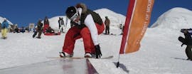 A snowboarder enjoying his Private Snowboarding Lessons for Kids (from 6 y.) & Adults of All Levels from Private Ski School Höll.