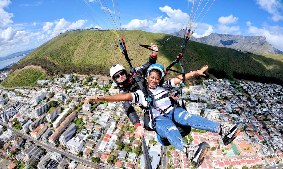 A woman enjoys her Paragliding in Cape Town from Signal Hill or Lion's Head with Hi5 Tandem Paragliding Cape Town