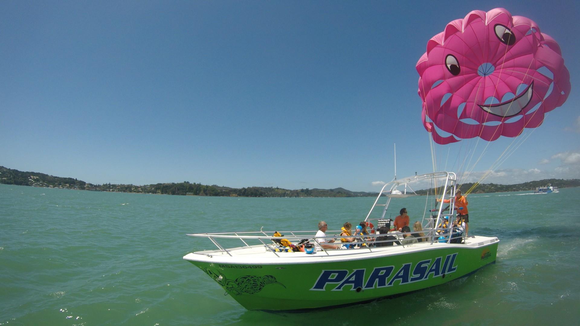 A group of tourists is preparing during the Parasailing in Paihia - For 1 Person organised by Bay of Islands Parasail for the take-off.