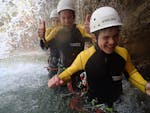 A boy is enjoying the time spent with his parents during the Canyoning for the whole Family organized by canyoning erleben.