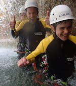 A boy is enjoying the time spent with his parents during the Canyoning for the whole Family organized by canyoning erleben.