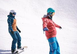 A kid is learning how to snowboard during kids snowboarding lessons with Top Secret ski and and snowboard school in Davos.