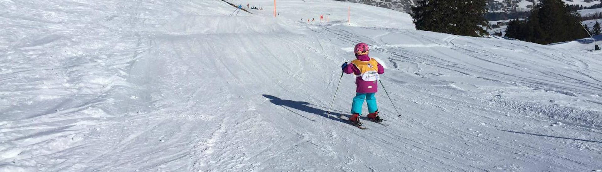 A young skier ist testing her new skiing skills during the Private Ski Lessons for Kids - All Levels organized by Swiss Ski School Chäserrugg.