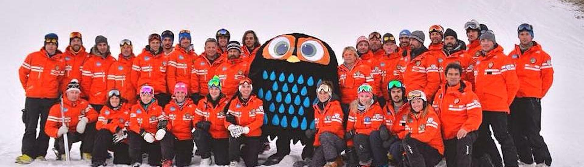 The Ski Lessons for Adults - All Levels is being cheered up by Tino il Civettino, the mascot of the Ski School  Scuola Italiana di sci Civetta.