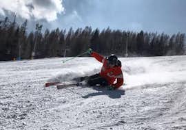 Private Ski Lessons for Adults of All Levels from Scuola Sci Civetta - Val di Zoldo Pecol An instructor during the Private Ski Lessons for Adults - All Levels of the Italian Ski School School Scuola Italiana di Sci Civetta are helping this man to improve.