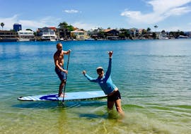 One of our guests getting accustomed to his paddle board during the stand up paddle boarding tour in Gold Coast private go vertical SUP