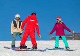 Snowboarders are listening to the instructions of their snowboarding instructor from the ski ESF du Dévoluy while attending their Snowboarding Lessons (from 8 years) - All Levels.