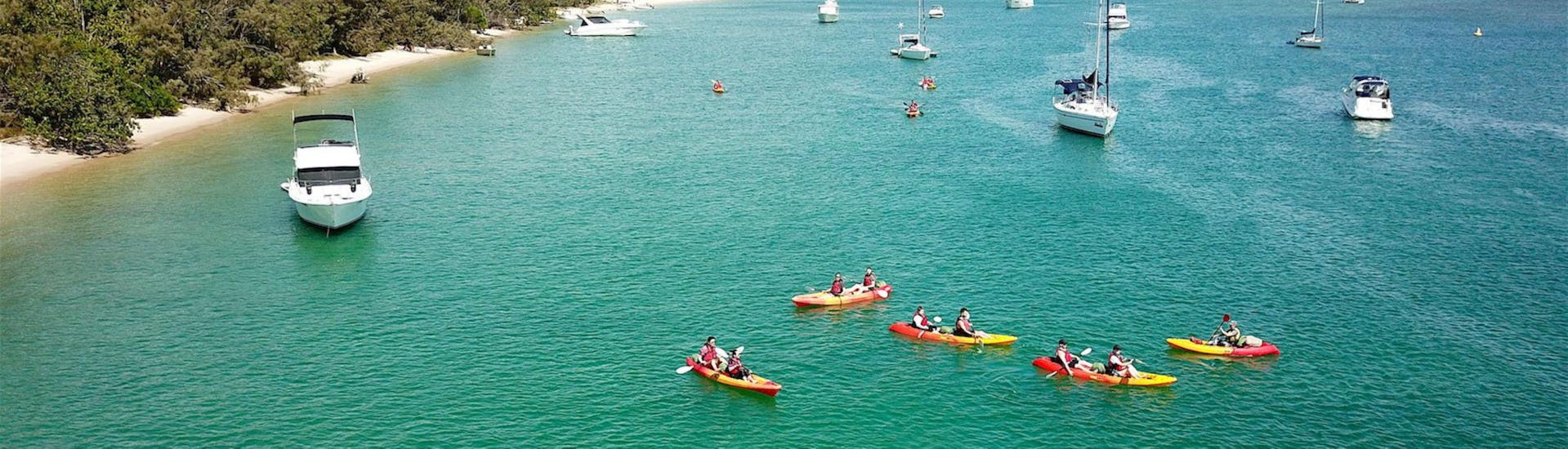 An aereal view of a group of people paddling across the broadwater during the tour Sea Kayaking in Gold Coast - 'Quick Escape' with Seaway Kayaking Tours.