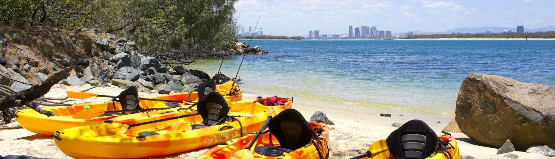 Four kayaks are lined up next to each other on the beach, ready for the guests taking part in the activity Sea Kayaking in Gold Coast - 'Chill-Out Tour' with Seaway Kayaking Tours.