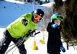 Cristallo ski instructor helping kid during private ski lesson.