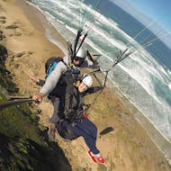 During the Paragliding in Wilderness - Adventure Flight, a qualified pilot from Dolphin Paragliding is flying with girl above stunning landscapes.