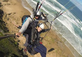 During the Paragliding in Wilderness - Adventure Flight, a qualified pilot from Dolphin Paragliding is flying with girl above stunning landscapes.