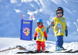 Two young skiers having fun during their kids ski lesson for baby skiers with the ESI Ozone in Les Orres. 