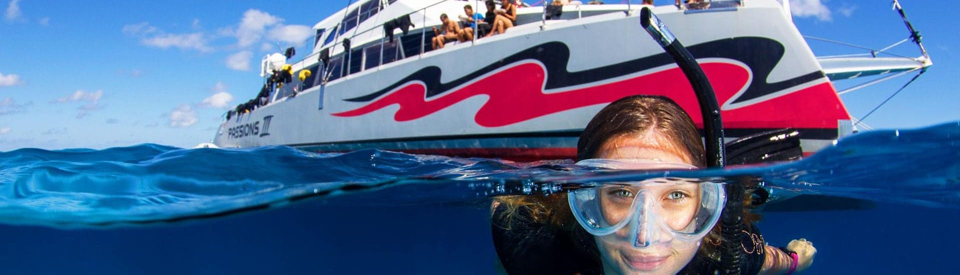 A young woman is exploring the marine wonderland during the Boat Tour with Snorkeling on the Great Barrier Reef organised by Passions of Paradise.