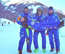 Some ski instructors are smiling at the camera having fun before give Private Ski Lessons for Adults - Beginner organized by the ski school Scuola di Sci Tre Nevi Ovindoli in the ski resort of Ovindoli on the Monte Magnola.