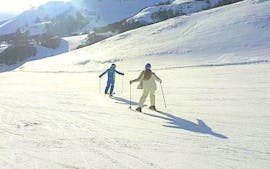 A private ski instructor is mastering the slope with a participant during the Private Ski Lessons for Adults - With Experience organized by the ski school Scuola di Sci Tre Nevi Ovindoli in the ski resort of Ovindoli on the Monte Magnola.