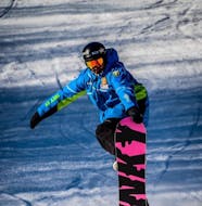 A private snowboard instructor is having fun on the slupes during the Private Snowboarding Lessons for Kids & Adults organized by the ski school Scuola di Sci Tre Nevi Ovindoli in the ski resort of Ovindoli on the Monte Magnola.
