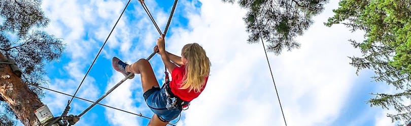 A young girl is trying her best inside the Adventure Park & Zipline in Varpolje with Funpark Menina - Savinji.
