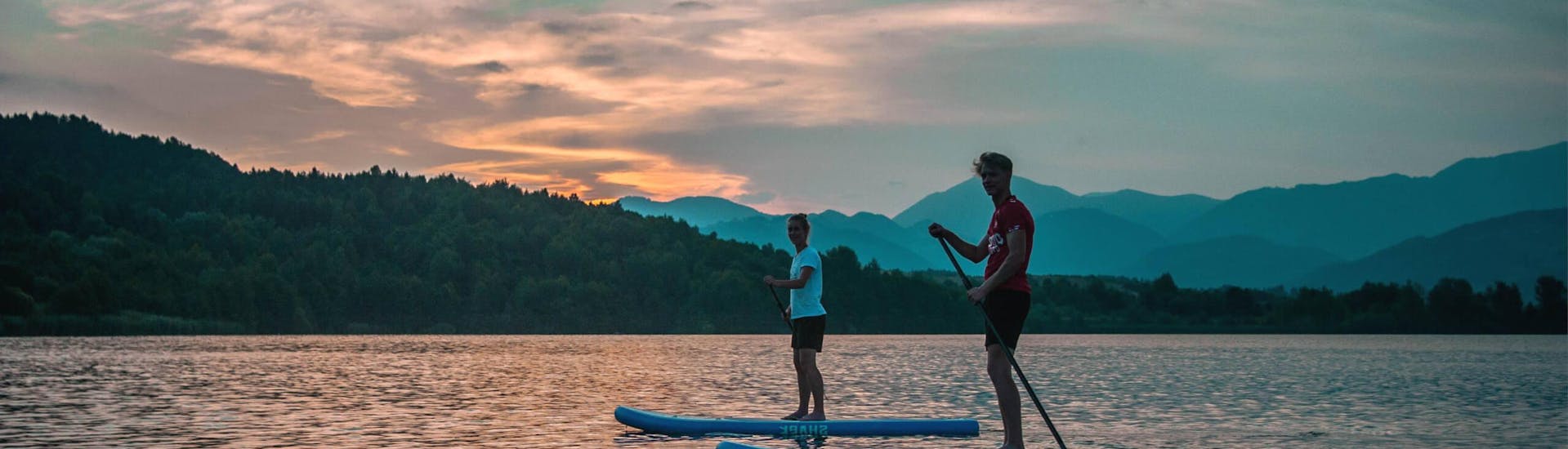 Watching magical sunset during Stand Up Paddle Sunset Tour - Lake Velenje organized by Funpark Menina
